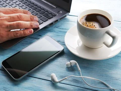 Coffee break. Office table with different gadgets on it. Top view. Stock Photos