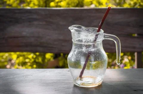 Coffee break is over. Empty glass of coffee with brown straw in yellow leaf Stock Photos