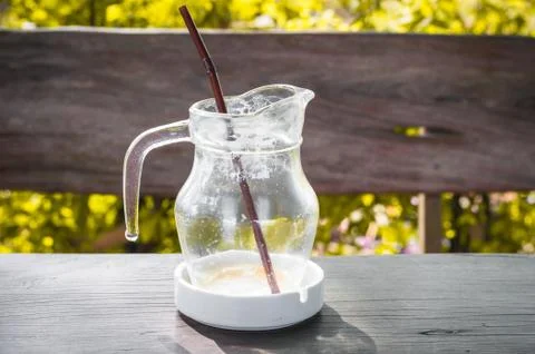 Coffee break is over. Empty glass of coffee with brown straw in yellow leaf Stock Photos