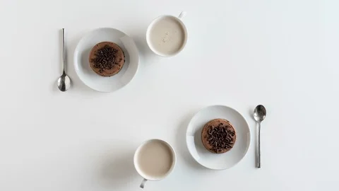 Coffee break with two chocolate cheesecakes. Flat lay. Time lapse Stock Footage 120648612