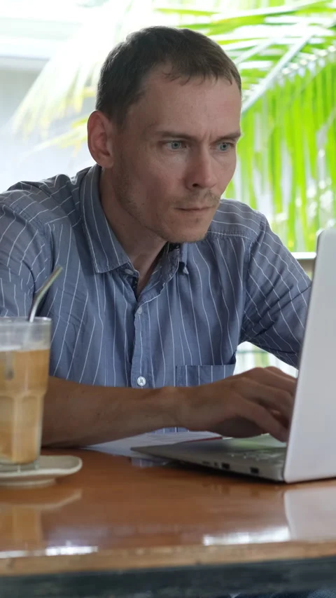 Coffee break while working on tropical terrace Stock Footage 315294661