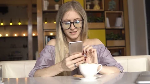 Coffee break. Woman write message to friend and smiling Stock Footage 85830179