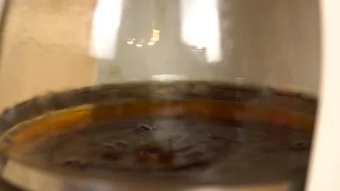 Coffee is brewed in a coffee maker. Coffee dripping into a flask with a drink Stock Footage 121472191