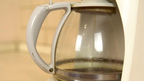 Coffee is brewed in a coffee maker. Coffee dripping into a flask with a drink Stock Footage 121472335