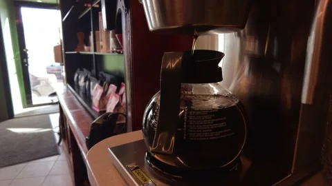 Coffee is brewed in a coffee maker in a coffee shop a cozy place breakfast flows Stock Footage 175960638