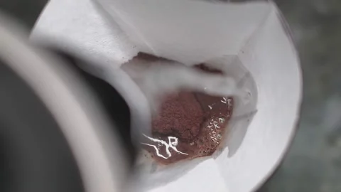Coffee is brewed with hot water from kettle in purover through paper filter Stock Footage 167765908