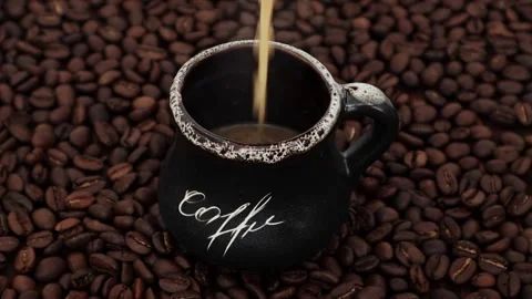 Coffee brewed with milk is poured into a cup. Stock Footage 199094503