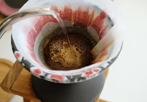 Coffee brewing process. Pouring water from gooseneck kettle. Freshly roasted Stock Photos