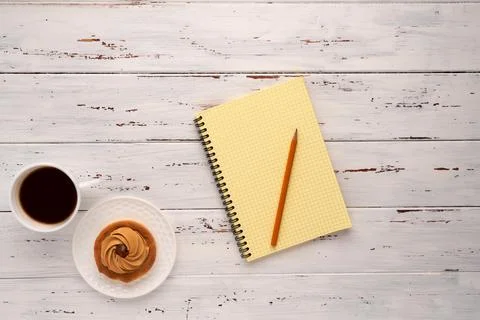 Coffee, cake and notepad on white table 写真素材