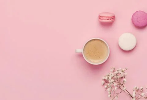 Coffee, cake macaron, clean notebook, eyeglasses and flower on p Stock Photos