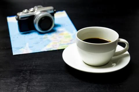 Coffee with camera and world map on wood background. Stock Photos