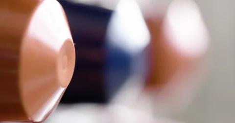 Coffee capsules in motion with blurred background Vídeo Stock 151348918