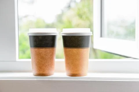 Coffee in cardboard brown cups ordered and delivered for takeaway, food delivery Stock Photos