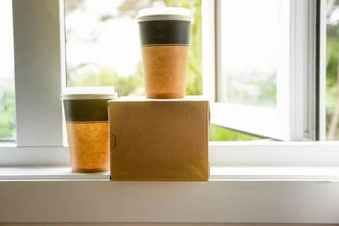 Coffee in cardboard brown cups ordered and delivered for takeaway, food delivery Stock Photos