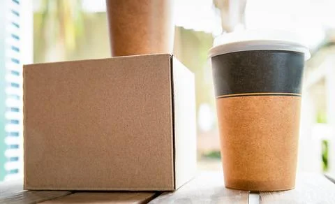 Coffee in cardboard brown cups ordered and delivered for takeaway, food delivery Stock Photos