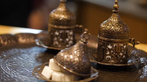 Coffee ceremony. man puts a copper cezve on a tray with oriental beautiful cups Stock Footage 126720036