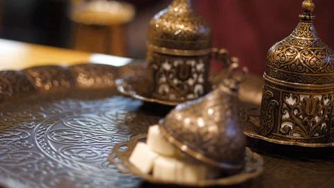 Coffee ceremony. man puts a copper cezve on a tray with oriental beautiful cups Stock Footage 126720059