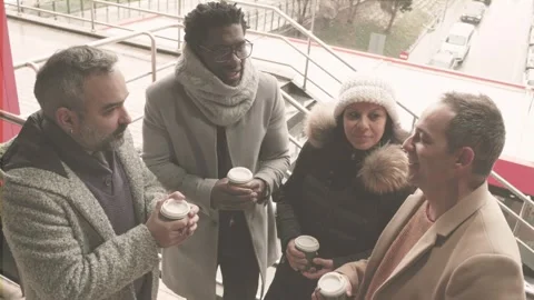 Coffee Chat Diverse Middle-Aged Colleagues on Rainy Street 動画素材 296351404