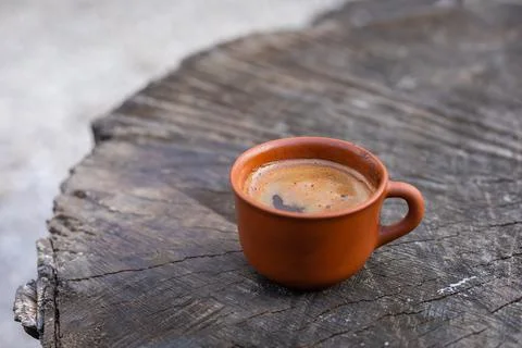 Coffee in a clay cup on the tree stump, selective focus, copyspace Stock Photos