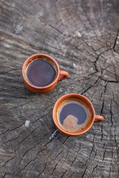 Coffee in a clay cup on the tree stump, selective focus, copyspace Stock Photos