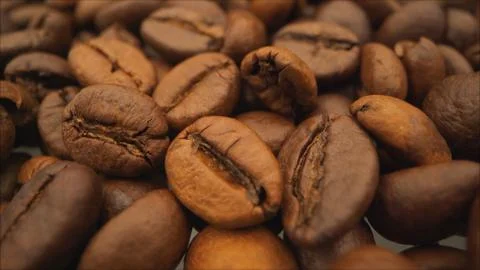 Coffee close up. Roasted coffee beans with. Coffee beans factory mixing. Macr Stock Photos