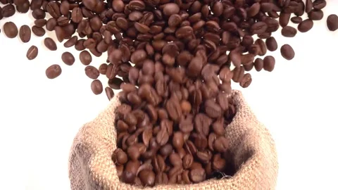 Coffee. Coffee beans are poured from the jute bag onto a white table. Stock-Footage 81828076