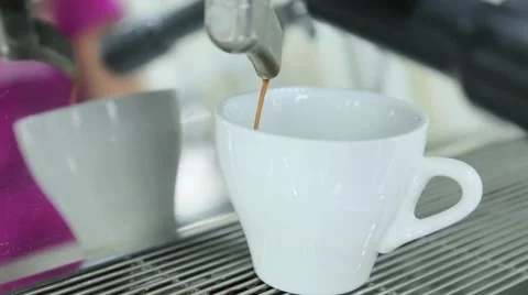Coffee from coffee machine is poured into coffee Stock Footage 63144847