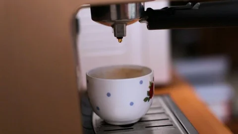 Coffee from a coffee machine is poured into a white cup Stock Footage 107411653