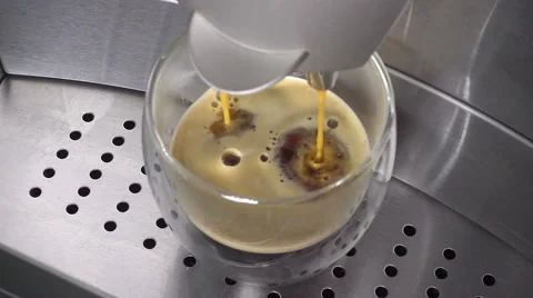 Coffee from coffeemaker flows in slow motion in a cup Stock Footage 67609691