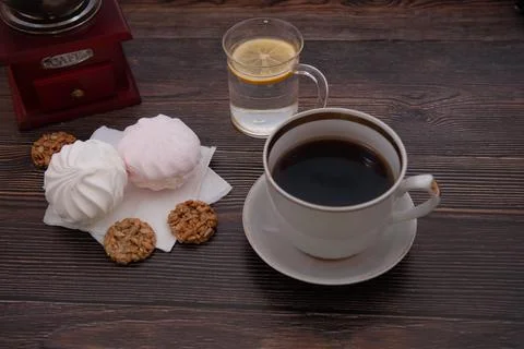 Coffee composition with coffee grinder, cup of coffee, cookies and marshmallows Stock Photos