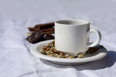 Coffee composition  with  white cup    of coffe  and beans of coffe, cinnamon Stock Photos