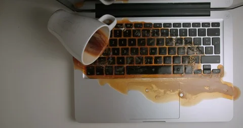 Coffee on computer splash pouring accident from above 4K Видео 127404563