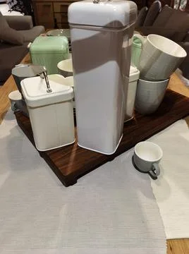 Coffee container with coffee cups on table Stock Photos