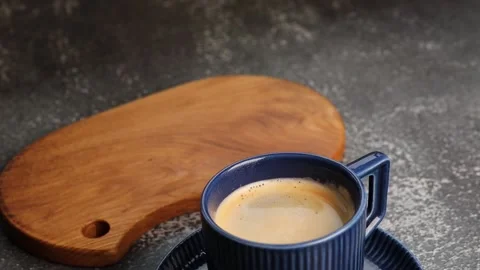 Coffee is cooling in a blue cup. Selective focus. A piece of white Stock Footage 226610950