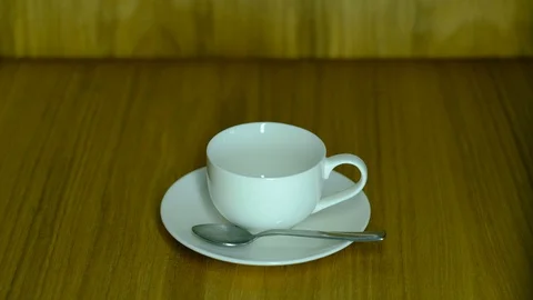 Coffee from a copper Turk is poured into a small white cup 스톡 동영상 129768402
