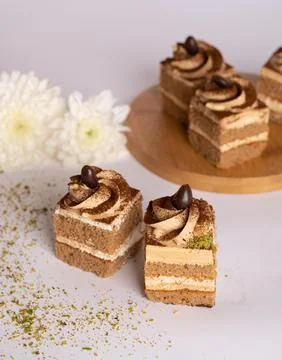Coffee cream layer cake cube topped with chocolate swirl and coffee bean Stock Photos