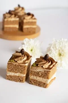 Coffee cream layer cake cube topped with chocolate swirl and coffee bean 库存照片