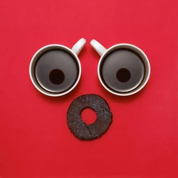 Coffee creative surprised face with two cups. Top view, flat lay Stock Photos