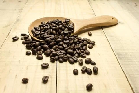Coffee crop beans on  spoon Photos