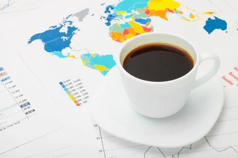  Coffee cup above world map and some financial documents Coffee cup above ... Stock Photos
