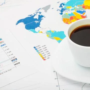  Coffee cup above world map and some financial documents Coffee cup above ... Stock Photos