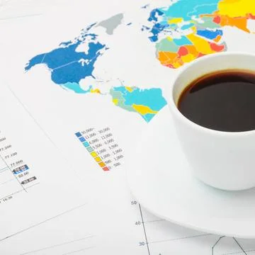Coffee cup above world map and some financial documents Coffee cup above w... Foto stock