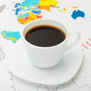 Coffee cup above world map and some financial documents Coffee cup above w... Stock Photos