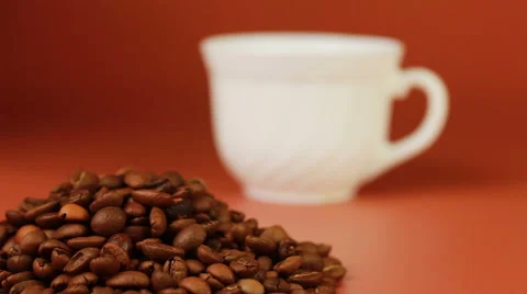 Coffee cup and beans on a brown background. Stock Footage 62994610
