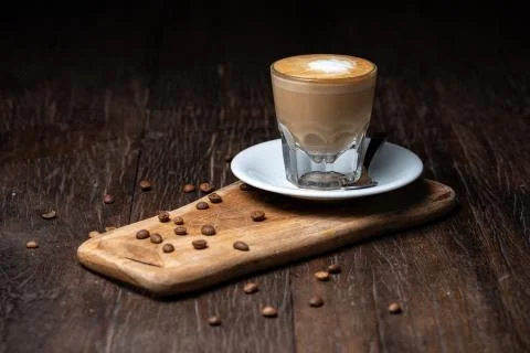 Coffee cup and beans on old kitchen table Cappuccino hot coffee with milk cup Stock Photos