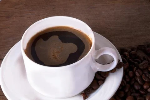 Coffee cup and beans. Stock Photos