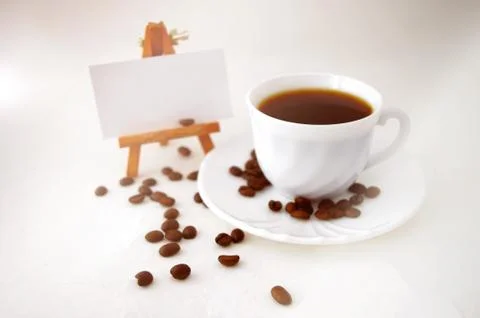 Coffee cup and beans on white background. Stock Photos