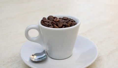 Coffee cup and beans on a white background. Top view with copy space for your Stock-Fotos