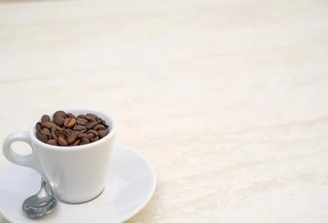 Coffee cup and beans on a white background. Top view with copy space for your Photos