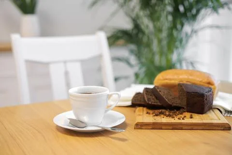 Coffee cup and bread on table Foto stock